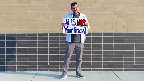 Man Holding AI Is Not Your Friend Protest Sign Stock Footage 337385002