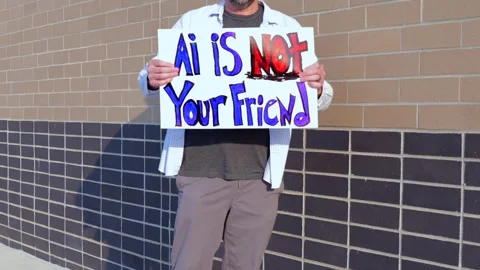 Man Holding AI Is Not Your Friend Protest Sign Stock Footage 337385007