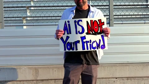 Man Holding AI Is Not Your Friend Protest Sign Stock Footage 337385016