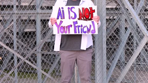 Man Holding AI Is Not Your Friend Protest Sign Stock Footage 337385018