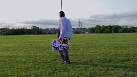 Man Holding AI Is Not Your Friend Protest Sign Stock Footage 337385019