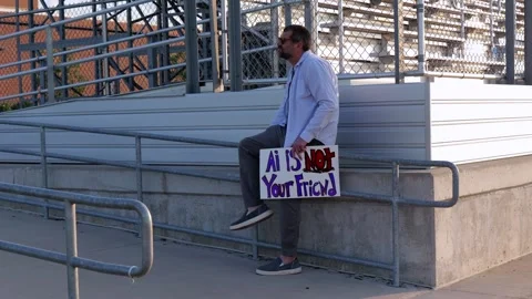 Man Holding AI Is Not Your Friend Protest Sign Stock Footage 337385023