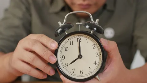 Man holding alarm clock, time management concept Stock Footage 141614383
