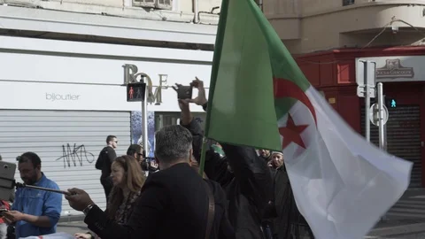 Man holding Algeria flag, protest in Marseille against president Bouteflika Stock Footage 104774924