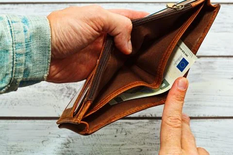 Man holding almost empty leather wallet Stock Photos