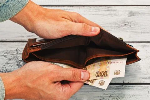 Man holding almost empty wallet with russian money Stock Photos