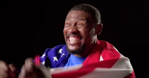 Man holding American flag, starting by waving and wrapping flag, celebrating Stock Footage 342721780