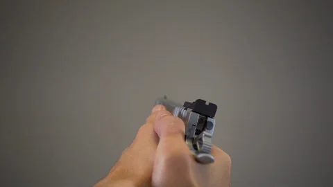 Man holding and displaying large silver handgun, aiming and pulling the Video stock 121297179