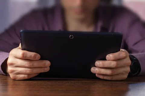 Man holding and using digital tablet, close up 写真素材