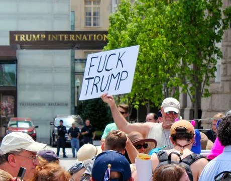 Man holding Anti-Trump sign Stock Photos