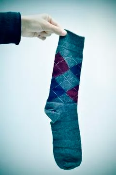 Man holding an argyle patterned sock, vignetted Stock Photos