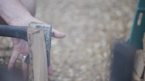 A man is holding an axe and is about to chop a log Stock Footage 301629440