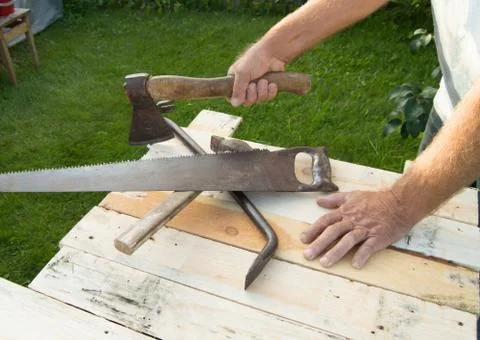 Man holding the axe, working with construction tools in his garden Stock Photos