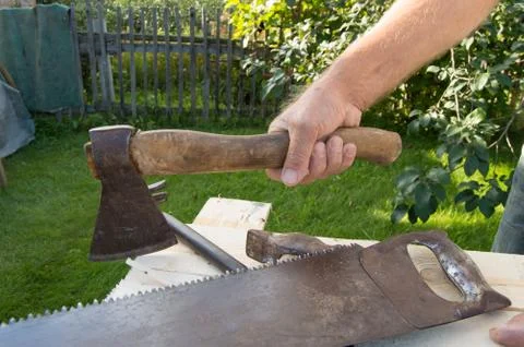 Man holding the axe, working with construction tools in his garden Stock Photos