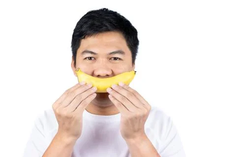 Man holding banana over face Stock Photos