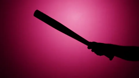 Man holding baseball bat close-up, shadow silhouette of hand with weapon on pink 库存影片 170736108