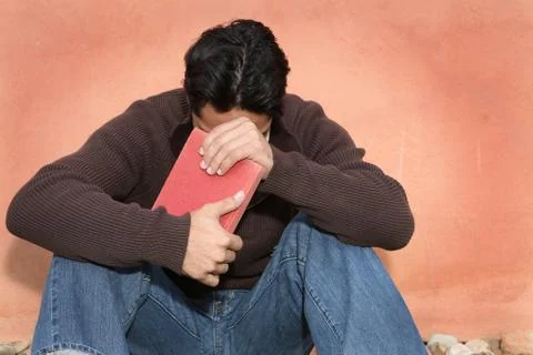 Man holding, bible while praying Stock Photos