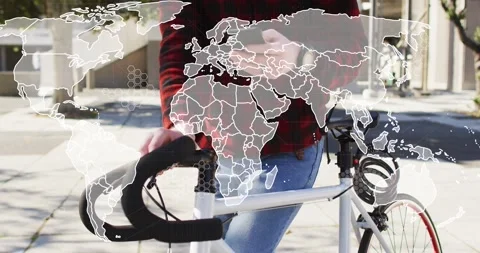 Man holding bicycle and tapping smartphone, causing world map overlay expanding Stock Footage 333833847