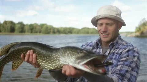 A man holding a big pike Stock Footage 11330270