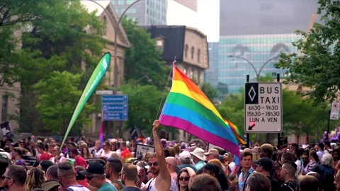 Man holding big pride flag in Montreal Gay Pride Celebration Stock Footage 114346684