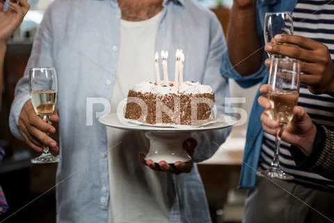 Man Holding Birthday Cake And Champagne Flute
