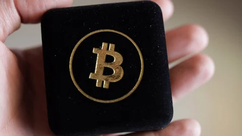 Man Holding Bitcoin Case In His Hand. Close Up shot Stock Footage 129635813