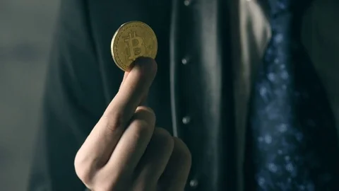 Man holding bitcoin in hand Stock Footage 83856275