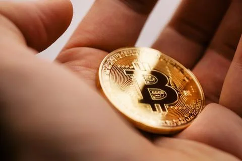 The man is holding bitcoin in the palm of his hand Stock Photos
