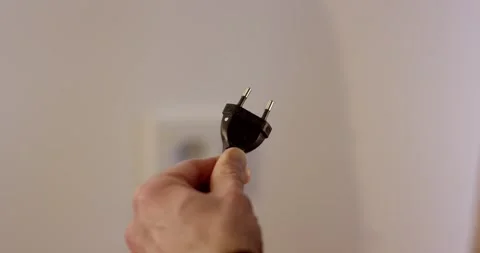 Man Holding Black Power Plug and White Cable, Indoor, Close Up Shot Stock Footage 341326711