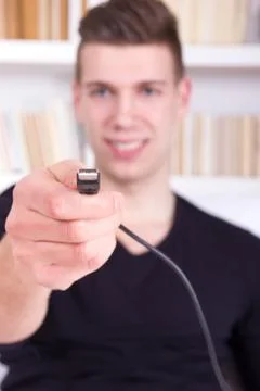 Man holding black usb cable Stock Photos