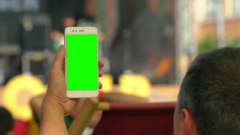 Man holding up a blank mobile at an event Video stock 115080775