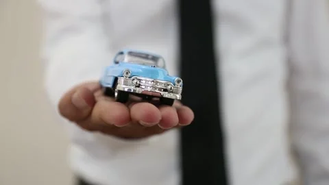 Man Holding A Blue Car Toward The Camera Stock Footage 344913279