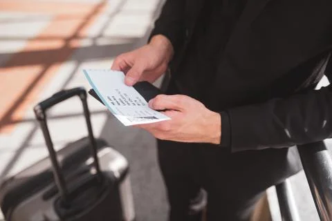 Man holding a boarding pass while travelling 스톡 사진
