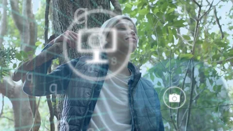 Man holding branch looking up starting tech HUD pulsing phone-chat icons on Stock Footage 333975523