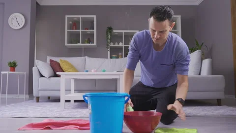 Man holding bucket under leaky ceiling and mopping floors. 스톡 동영상 218812625