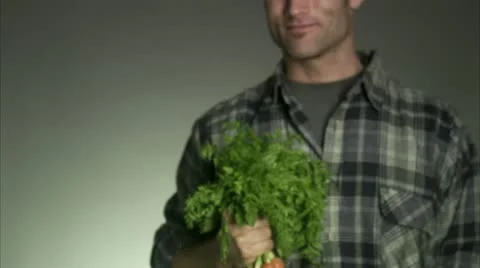 Man holding a bunch of carrots Stock Footage 11291044