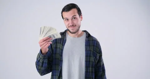 Man holding bundle of cash dollars Stock Footage 143944556