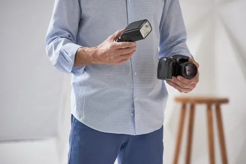 Man holding camera and flash Stock Photos