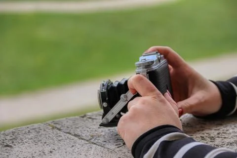 A man is holding camera to shoot something by his hand Stock Photos