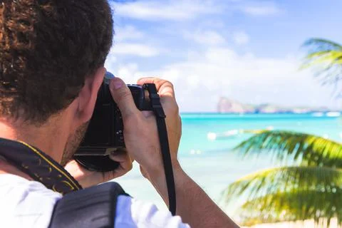 Man holding the camera which taking photo of Beautiful landscape with ocean Stock Photos