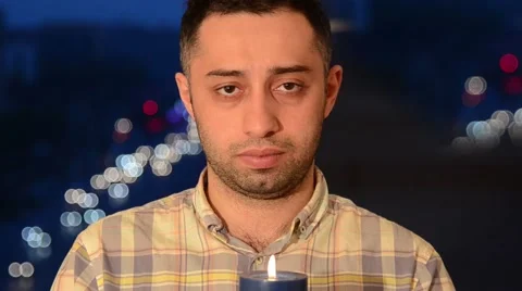 Man Holding Candle Looking at Camera Stock Footage 49812251