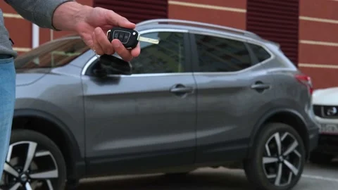 The man is holding the car keys. Stock Footage 157085133