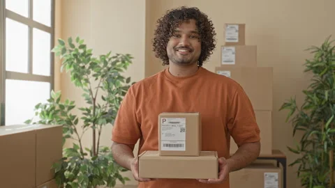 Man holding cardboard boxes in building office while smiling and offering p.. Stock Footage 337402690