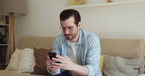 Man holding cellphone read received sms with super great news Stock Footage 135586273