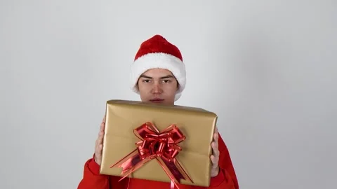 The man is holding a Christmas present Stock Footage 319824914