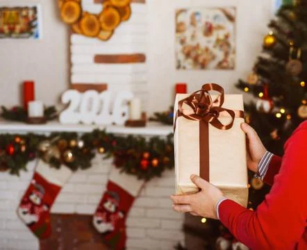 Man holding Christmas present Stock Photos
