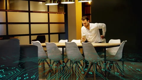 Man holding coffee cup and smartphone in office, displaying business tech Stock Footage 308655988
