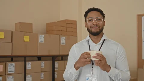 Man holding coffee mug with both hands, smiling with eyes closed, hands vis.. Video stock 337440027