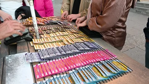 Man holding coin and scratching lottery ticket. Scratch Stock Footage 292014250