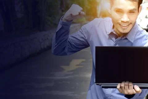 Man holding computer and put hand up on air. Stock Photos